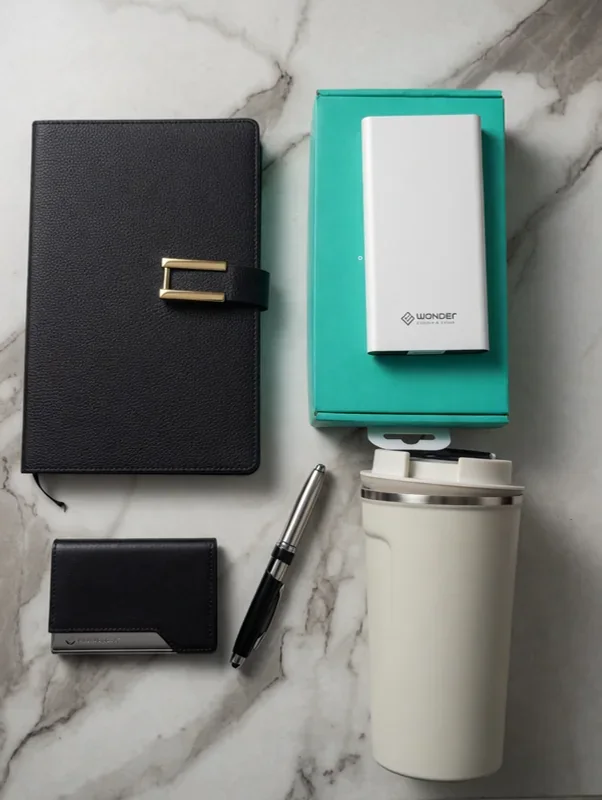 Coordinated corporate gift concept featuring notebooks, drinkware and accessories
